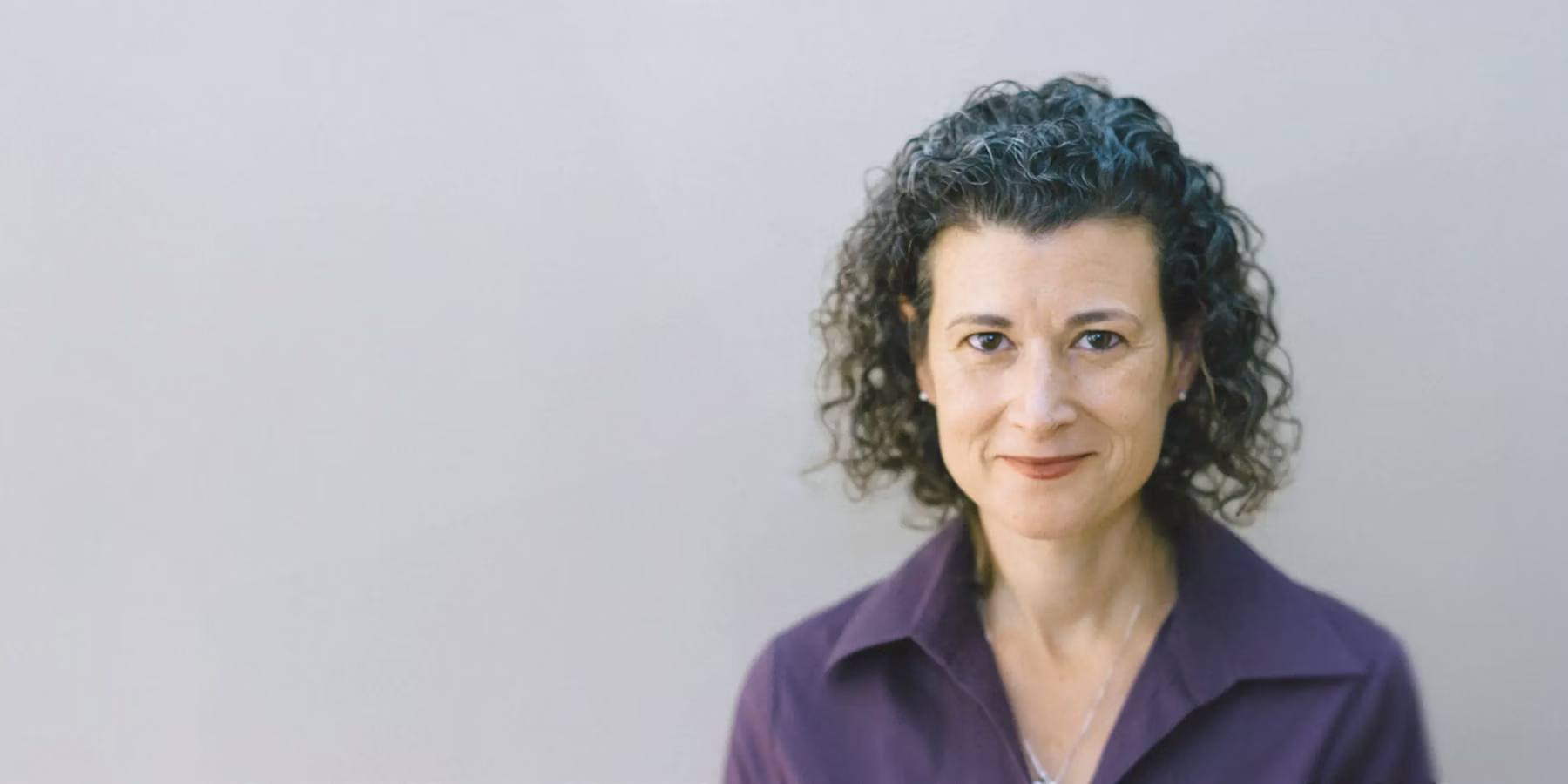 Portrait of a woman indoors next to a testimonial about Mercury’s built-in permissions.